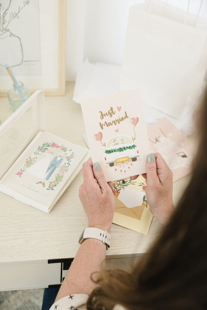 A woman is holding a card that features an image of a van, showcasing her interest or connection to the vehicle.